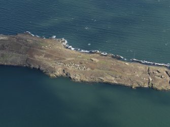 Oblique aerial view centred on S defences, taken from the SW.