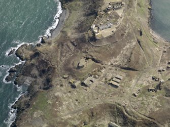 Oblique aerial view centred on the central defences and part of the northern defences, taken from the NW.