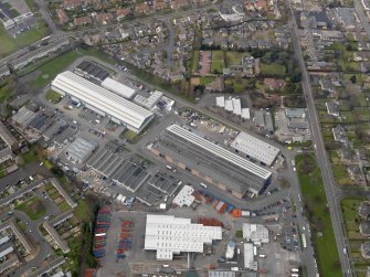 Oblique aerial view centred on the aircraft hangars with Avon Hall adjacent, taken from the SE.