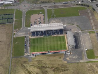 Oblique aerial view centred on the football ground, taken from the WNW.