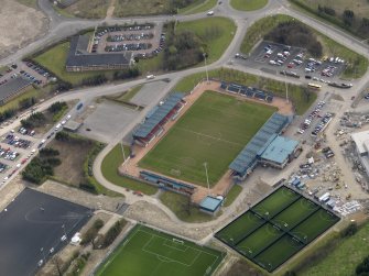 Oblique aerial view centred on the football ground, taken from the NW.