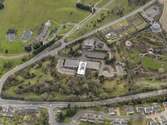 Oblique aerial view centred on the Distillers Head Office with the gardens adjacent, taken from the N.