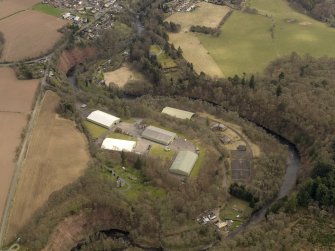 Oblique aerial view centred on part of the Naval Stores Depot with Cromwellpark House adjacent , taken from the NNW.
