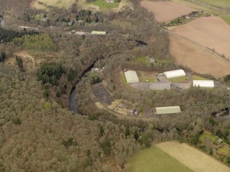 Oblique aerial view centred on part of the Naval Stores Depot with Cromwellpark House adjacent , taken from the SSW.