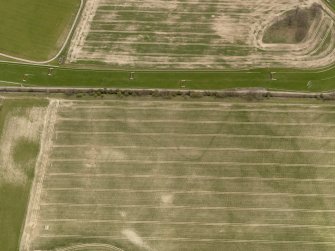 Oblique aerial view centred on the remains of the temporary camp, taken from the N.