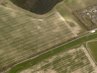 Oblique aerial view centred on the remains of the temporary camp, taken from the SW.