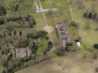 Oblique aerial view centred on the Palace with the Stable Block adjacent, taken from the NW.