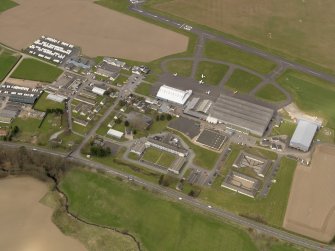 Oblique aerial view centred on the technical area of the airfield, taken from the SSE.