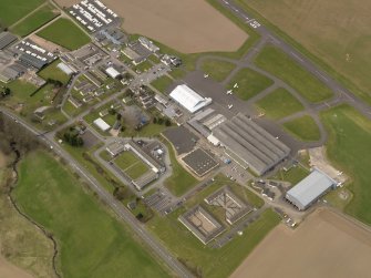 Oblique aerial view centred on the technical area of the airfield, taken from the SE.