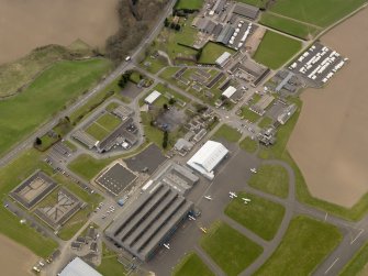 Oblique aerial view centred on the technical area of the airfield, taken from the NE.