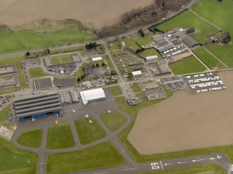 Oblique aerial view centred on the technical area of the airfield, taken from the N.