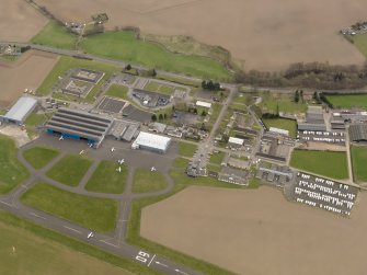 Oblique aerial view centred on the technical area of the airfield, taken from the NW.