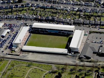 Oblique aerial view centred on the football ground taken from the NW.