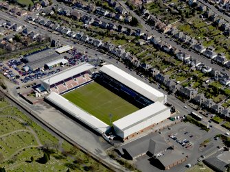 Oblique aerial view centred on the football ground taken from the WNW.