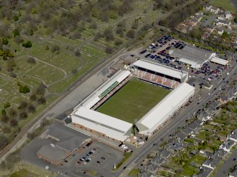 Oblique aerial view centred on the football ground taken from the SW.