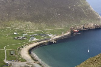 Village Bay, Ministry of Defence Establishment. Elevated general view from SW, including including the Factor's House, quay, manse, the Feather Store and the Spinningdale.