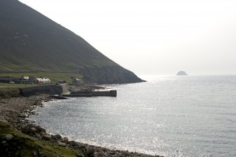 Village Bay, Quay. General view from NW with SW slope of Oiseval and Levenish in the distance.