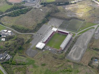 Oblique aerial view centred on the football ground, taken from the NW.