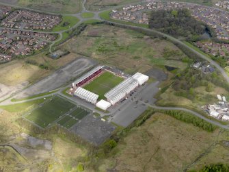 Oblique aerial view centred on the football ground, taken from the SE.