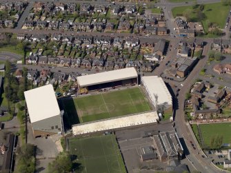 Oblique aerial view centred on the football ground, taken from the E.