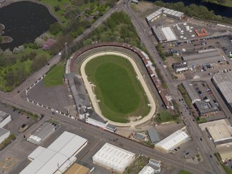 Oblique aerial view centred on the greyhound stadium, taken from the S.