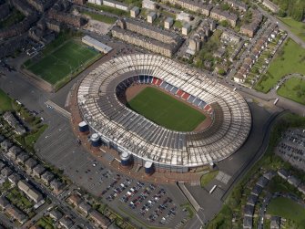 Oblique aerial view centred on the football stadium, taken from the SE.