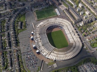 Oblique aerial view centred on the football stadium, taken from the E.