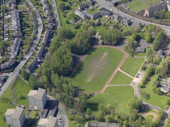 Oblique aerial view centred on the remains of the football ground, taken from the NE.