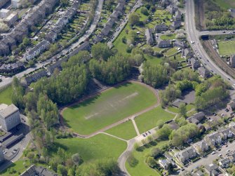 Oblique aerial view centred on the remains of the football ground, taken from the NNE.