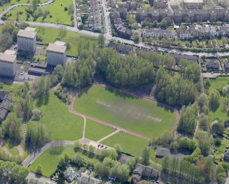 Oblique aerial view centred on the remains of the football ground, taken from the NW.