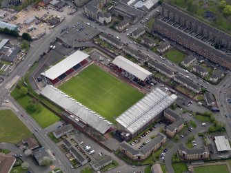 Oblique aerial view centred on the football ground, taken from the NW.