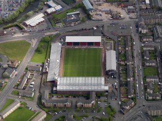 Oblique aerial view centred on the football ground, taken from the W.