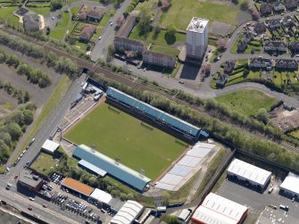 Oblique aerial view centred on the football ground, taken from the NW.