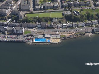 Oblique aerial view centred on the open air pool, taken from the NW.