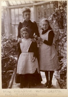 Portrait of Miss Milledge with Gretta and Theodora, possibly in the conservatory at Kinnaird House.
