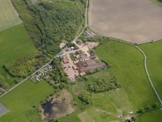 Oblique aerial view centred on the brickworks, taken from the NW.