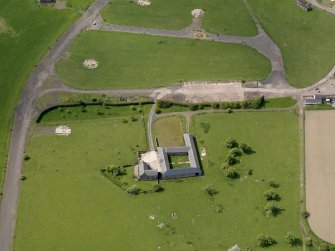 Oblique aerial view centred on Muirhouses farmsteading  with the airfield dispersal area adjacent, taken from the ENE.