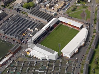 Oblique aerial view centred on the football ground, taken from the E.