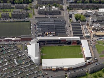 Oblique aerial view centred on the football ground, taken from the NNE.