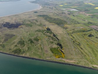 General oblique aerial view centred on the firing ranges with the golf course adjacent, taken from the E.