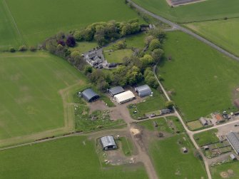 Oblique aerial view centred on the aircraft hangars with Hatton House adjacent, taken from the NE.