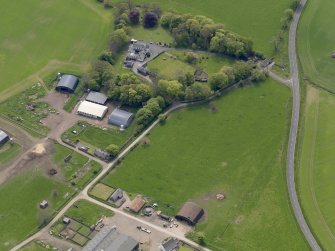 Oblique aerial view centred on the aircraft hangars with Hatton House adjacent, taken from the NNE.