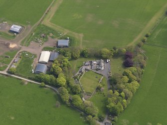 Oblique aerial view centred on the aircraft hangars with Hatton House adjacent, taken from the NW.