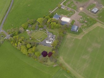 Oblique aerial view centred on the aircraft hangars with Hatton House adjacent, taken from the S.