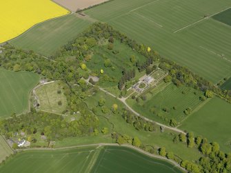 General oblique aerial view centred on the country house with the policies adjacent, taken from the SW.