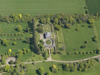 Oblique aerial view centred on the house with the gardens adjacent, taken from the WSW.
