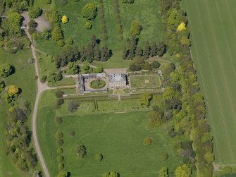 Oblique aerial view centred on the house with the gardens adjacent, taken from the S.