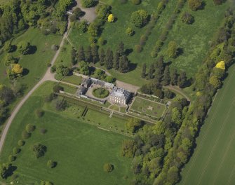 Oblique aerial view centred on the house with the gardens adjacent, taken from the SSE.