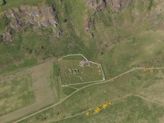 General oblique aerial view centred on the remains of the church with the churchyard adjacent, taken from the SE.