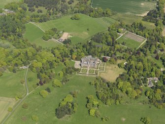 General oblique aerial view centred on the country house with the policies and gardens adjacent, taken from the SW.